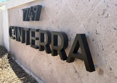 Modern black 3D sign reading 1247 CANTERRA on a stone wall in Phoenix, designed by Arizona Custom Signworks.