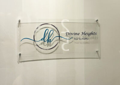 Clear acrylic sign for Divine Heights Hair by Kathy featuring elegant script, installed by Arizona Custom Signworks in Phoenix salon.