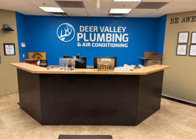 Deer Valley Plumbing lobby in Phoenix, featuring a custom wall sign by Arizona Custom Signworks, showcasing professional signage design.